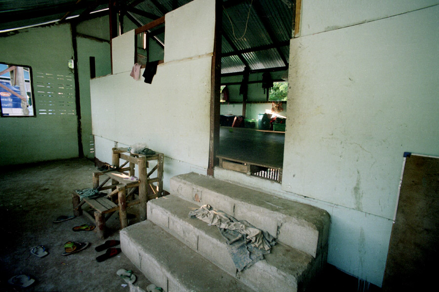 Agape School and Orphanage: Even at a well-supported place like Agape, buildings can seem poor to those unfamiliar with migrant schools. Students leave shoes outside of the classroom (and most indoor spaces in Mae Sot) to reduce the amount of dirt tracked inside.<br><br>**NOTE: Agape faced scandal in 2013 when its then-revered headmaster was accused of molestation and fled to Myanmar rather than face the police. The former headmaster spoke English well and solicited a great deal of support from foreigners, continuing to do so from unsuspecting friends after leaving Thailand.