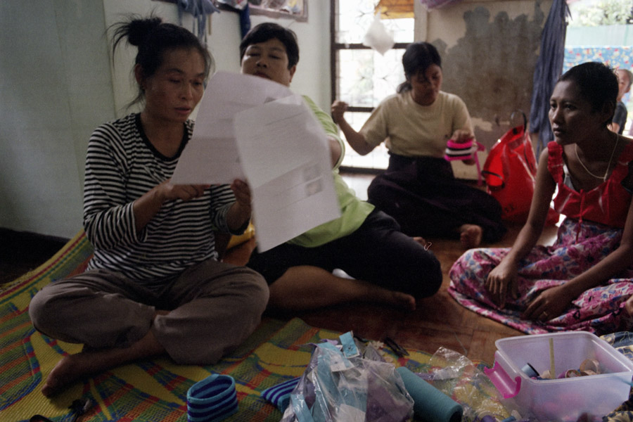 2011: Tailors with Social Action for Women study a new proposed design from a donor. SAW works with displaced Burmese women on rights awareness, vocational training, child protection, HIV/AIDS support, and more, including this income-generation program.