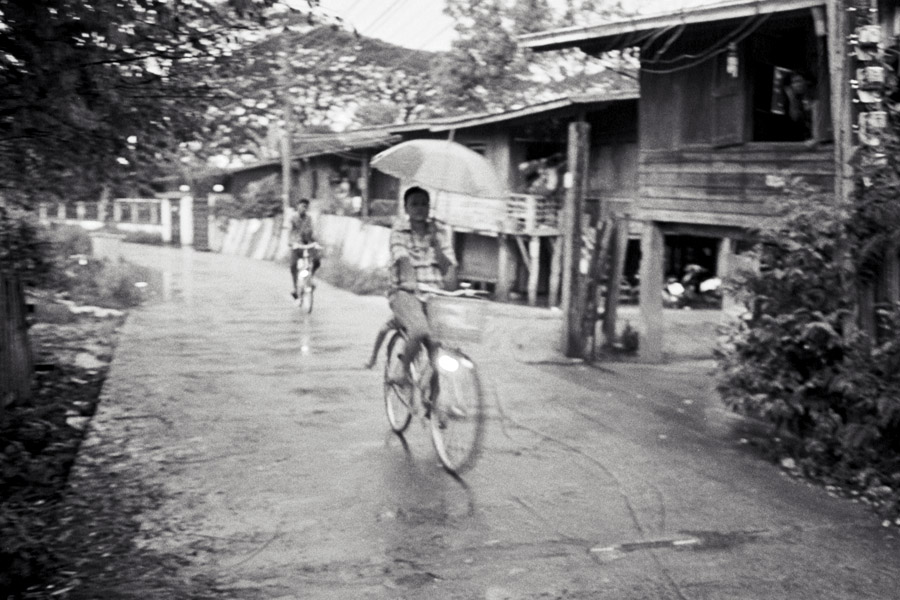 2011: Bicycles are the most common form of transportation in Mae Sot, and with a long, intense rainy season, most residents become adept at riding while holding umbrellas.