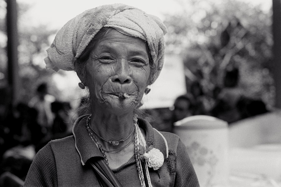 2011: At the traditional Karen ethnic group's 'wrist-tying festival', held yearly usually in August. Mae Sot has a huge celebration encompassing ethnic Karen who are nationals of either country, and welcomes the whole community, but in 2011 I attended a small Thai-only celebration in Padaeng village nearby. <br><br>This woman wears modified versions of traditional clothing and jewelry; many old women have exchanged their headscarves for thin towels these days.