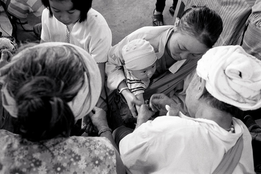 2011: At the traditional Karen ethnic group's 'wrist-tying festival', held yearly usually in August. Mae Sot has a huge celebration encompassing ethnic Karen who are nationals of either country, and welcomes the whole community, but in 2011 I attended a small Thai-only celebration in Padaeng village nearby. <br><br>Tying strings provides blessings. Many elders are asked to tie the wrists of babies.