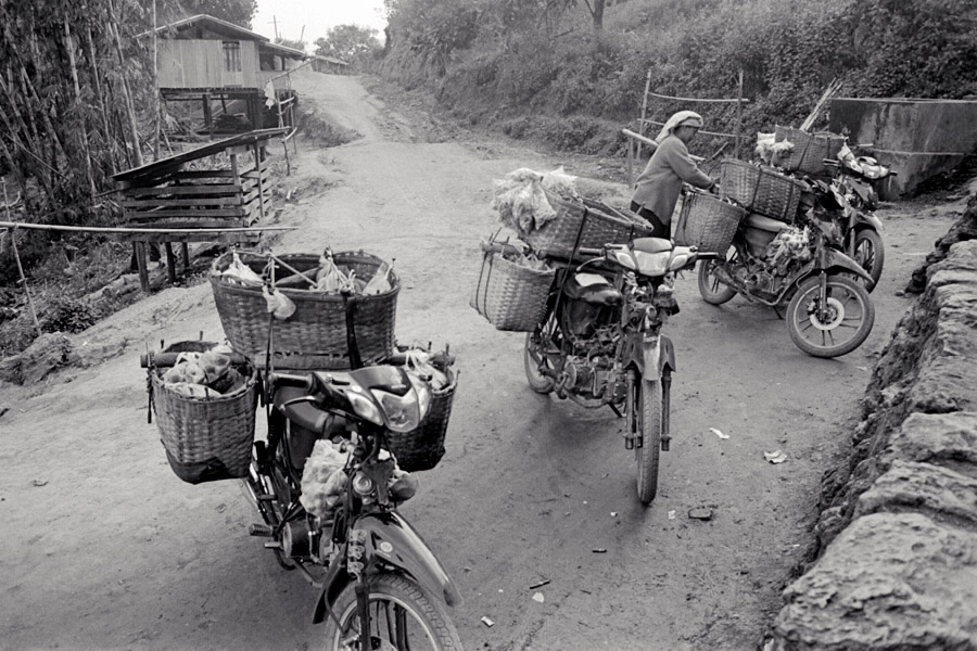 Pan Nyung village, Northern Shan State 2011: mobile grocery vendors parked outside a tiny local shop.