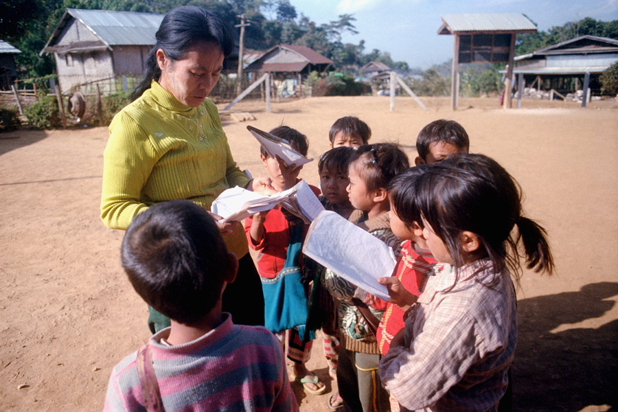 Northern Shan State, 2015: primary school teacher checks students' homework.