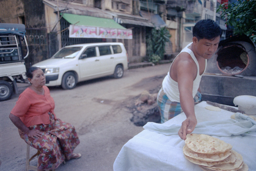 Yangon 2013: Burmese naanbya is a smaller version of Indian naan, and generally served in Muslim teashops with curries or chickpea salad. This vendor was more unusual, with a streetside oven in front of one of Yangon's many mosques, selling only take-away flatbread.