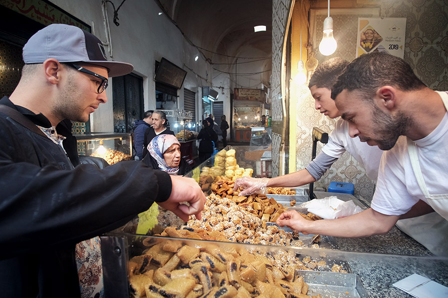 Tunis, Tunisia 2018: selling traditional date or sesame sweets called makroub in the medina.