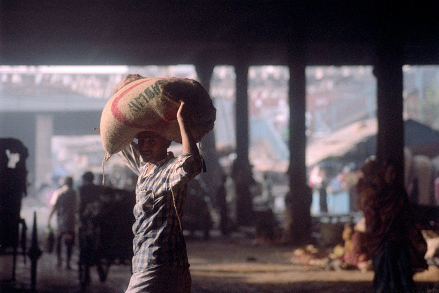 Kolkata, India 2014: Moving products under Howrah Bridge in the famed Mallick Ghat flower market.
