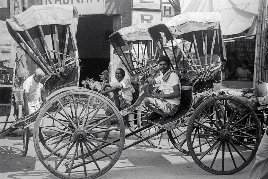 Kolkata, India 2015: Rickshaw pullers. Kolkata is the last part of India with this colonial remnant in use, although bicycle rickshaws still exist elsewhere. Here, hand-pulled rickshaws weave through traffic next to more-typical auto rickshaws. The government has declared the practice inhumane and no longer issues licenses, which is of great concern to the thousands of migrant workers who depend on pulling rickshaws for their livelihoods.