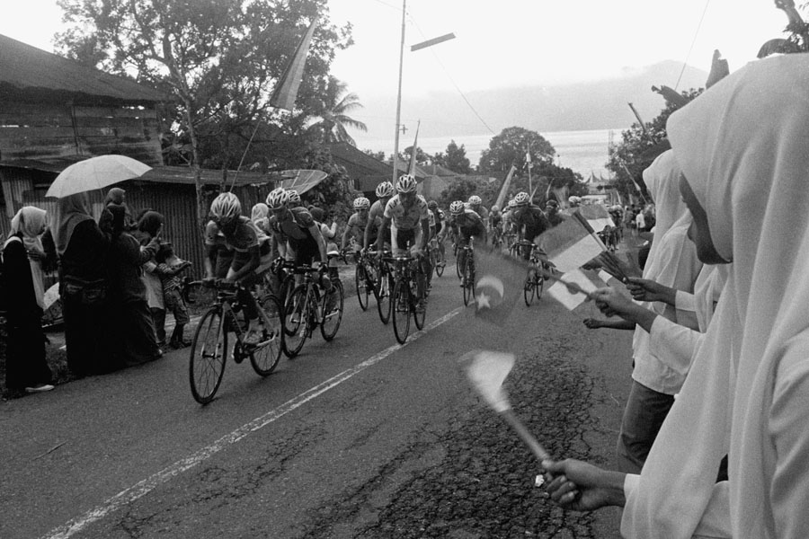 Maninjau, Sumatra, Indonesia 2013: a huge bicycle race through West Sumatra called Tour de Singkarek steeply climbs the winding road from Lake Maninjau to Bukittingi.