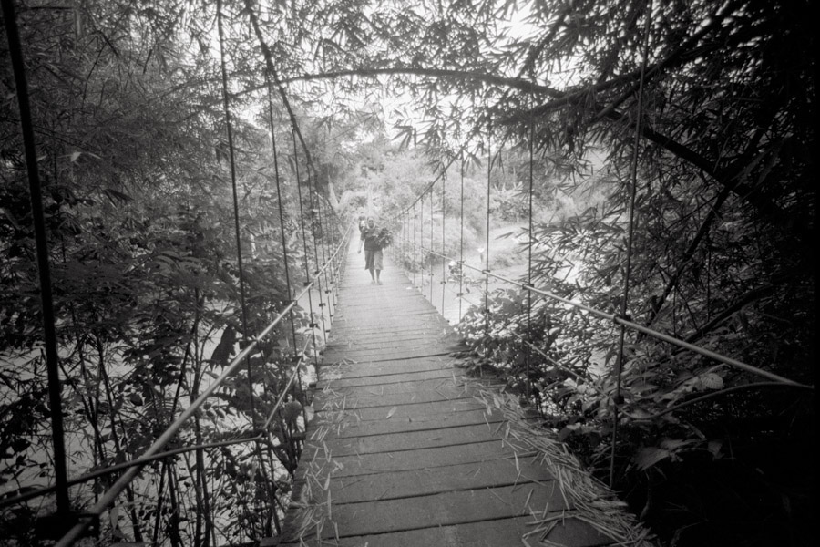 Tana Toraja, Sulawesi, Indonesia 2010: Many parts of Tana Toraja lack smooth roads or sturdy bridges. Although most locals pile multiple riders onto a motorcycle to get around, it's safer to walk across rickety suspension bridges like this.