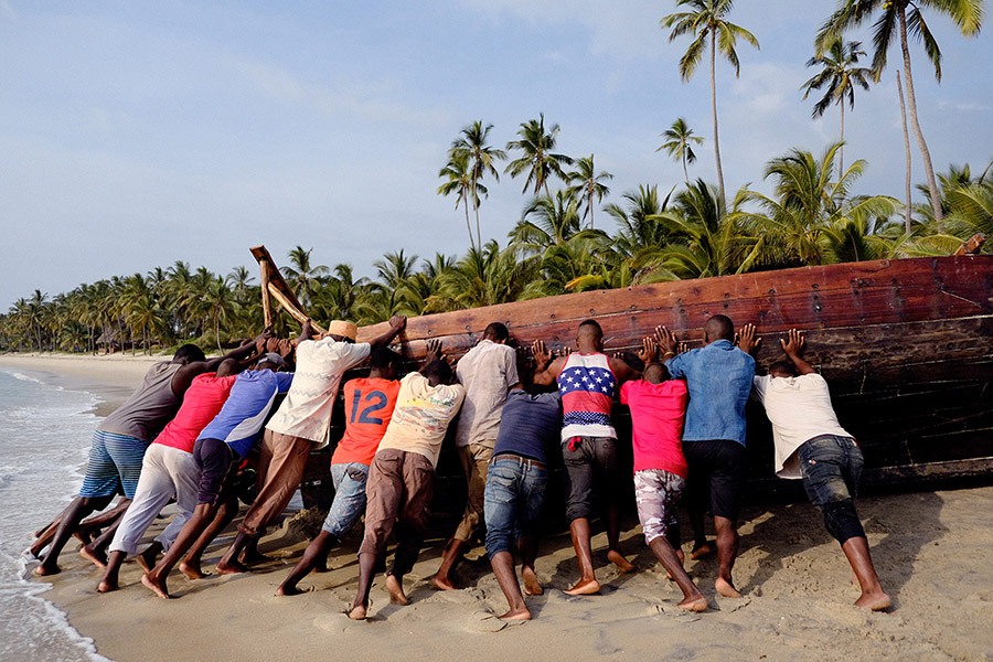 Ushongo, Tanzania 2018: working together to push a large boat uphill for maintenance.