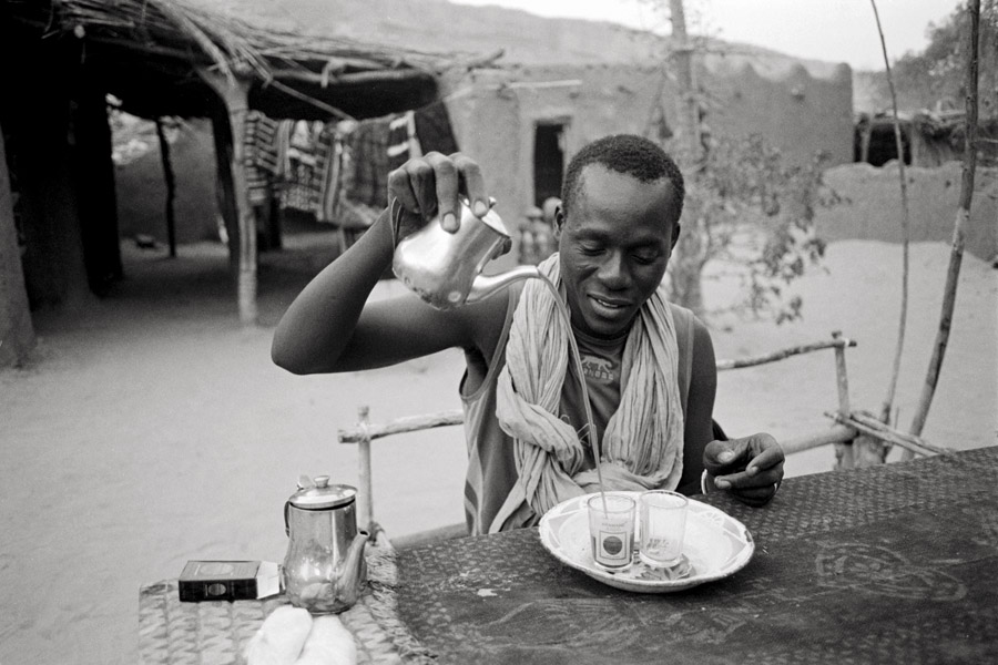 Ende, Mali (Dogon Country) 2010: tea in Mali is poured multiple times from up high to create froth.