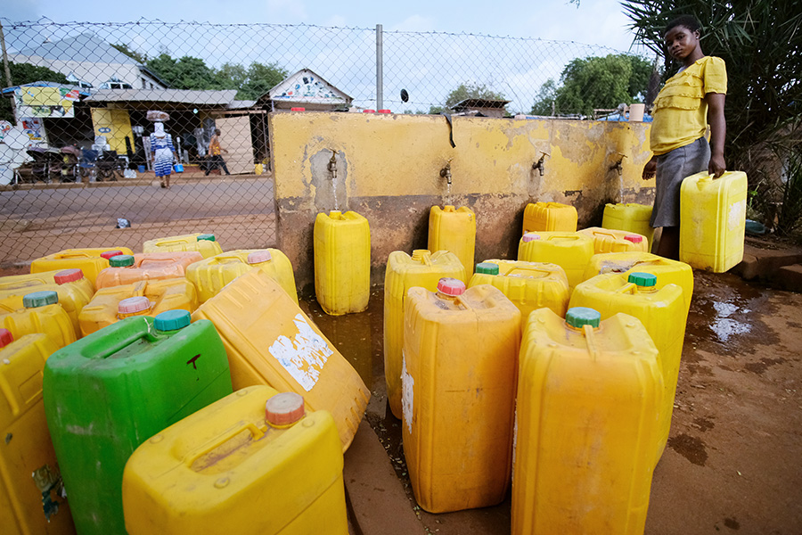 Tamale, Ghana 2018: jerry cans (oil containers) are repurposed throughout Africa for fetching water. This water station in central Tamale was installed by a local NGO.